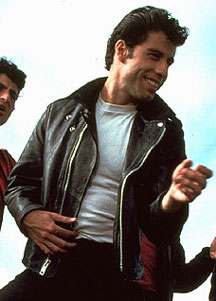 John Travolta as Danny Zuko in Grease wearing a leather jacket